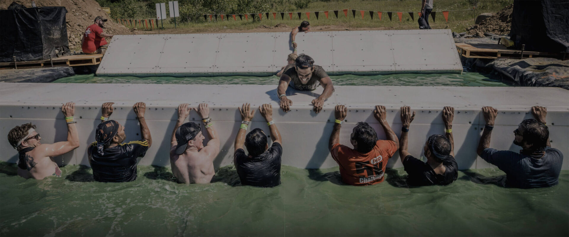 A team helping their teammate go to other side of the ramp